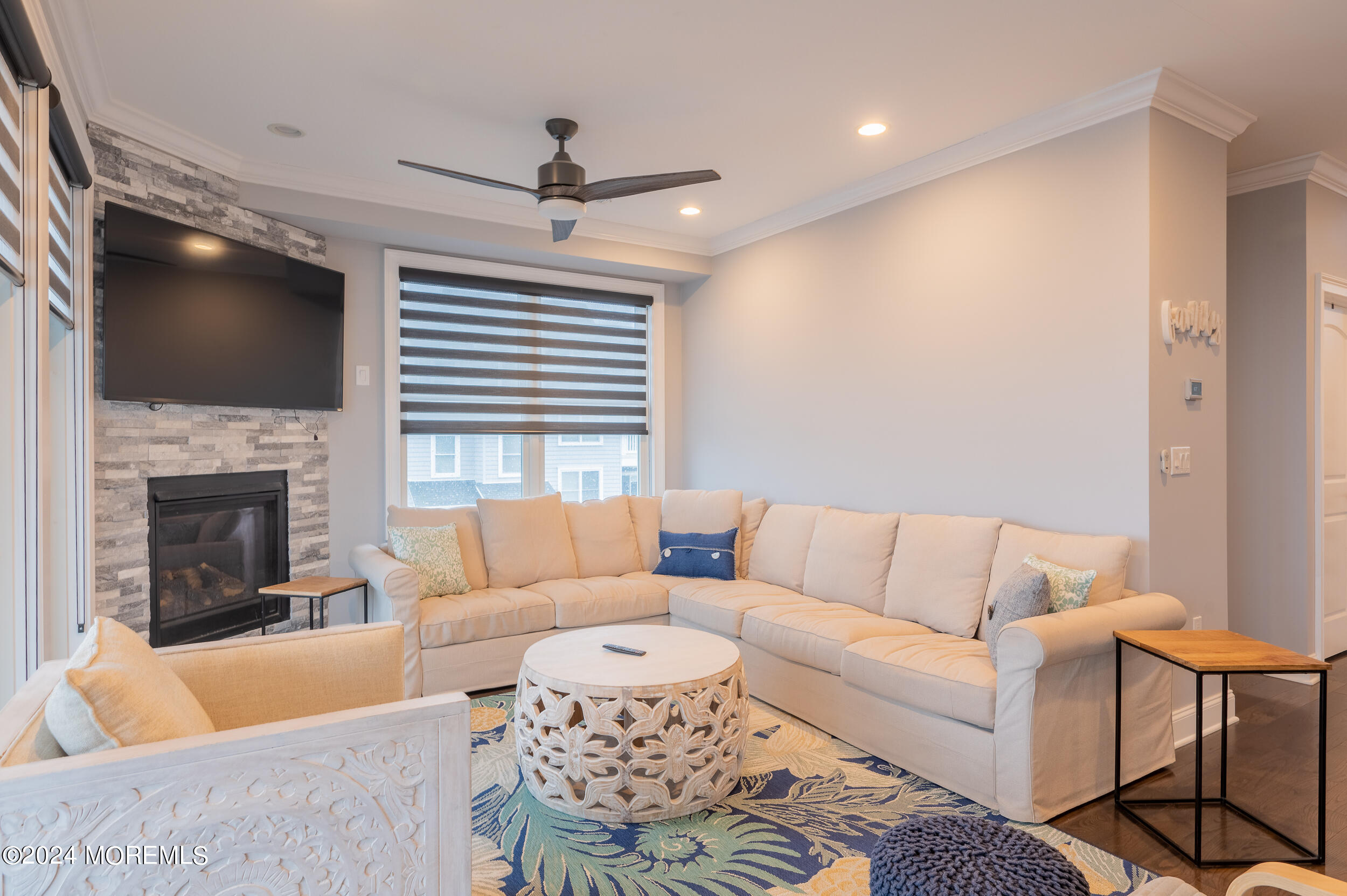 1851 Oceanfront Seaside Heights, NJ 08751 - Photo 27 of 66 a living room with furniture a flat screen tv and a fireplace