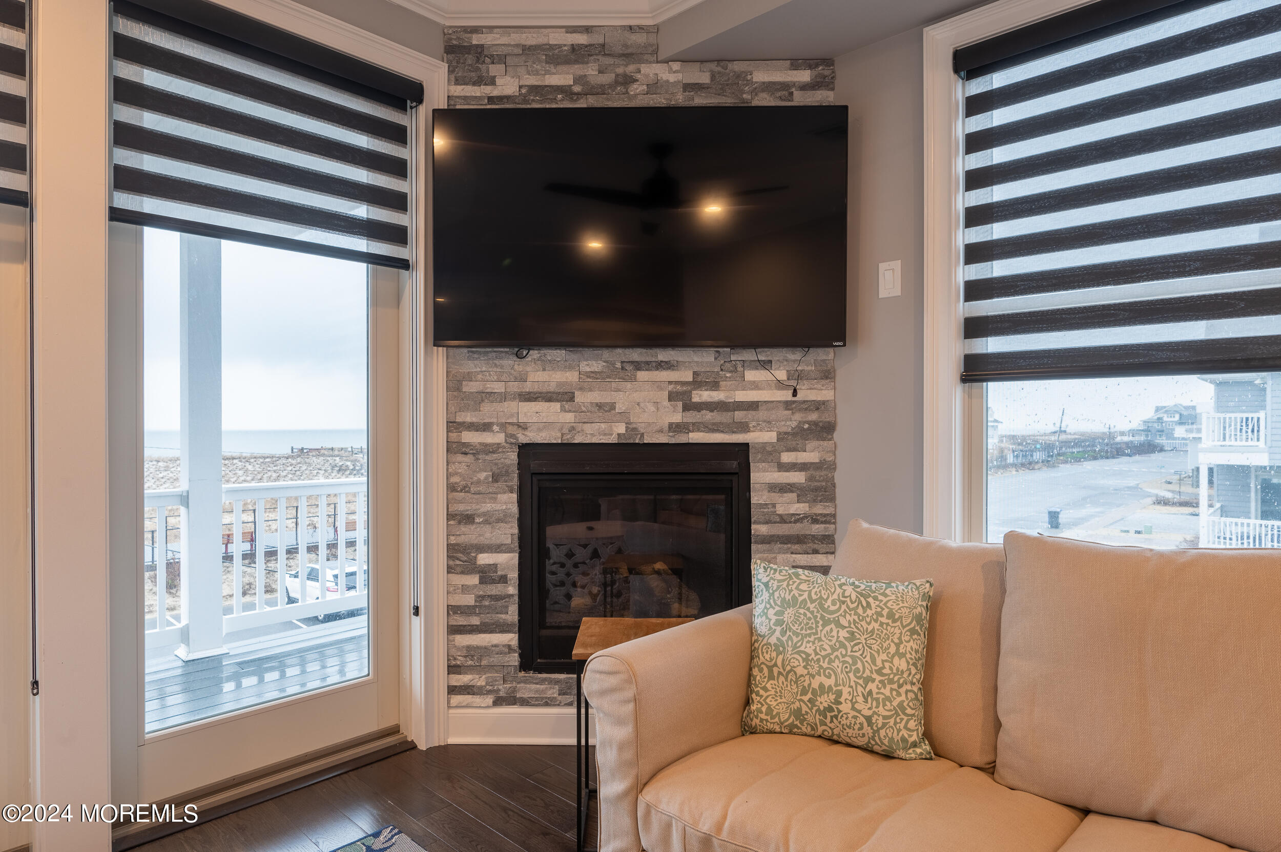 1851 Oceanfront Seaside Heights, NJ 08751 - Photo 28 of 66 a living room with furniture a flat screen tv and a fireplace