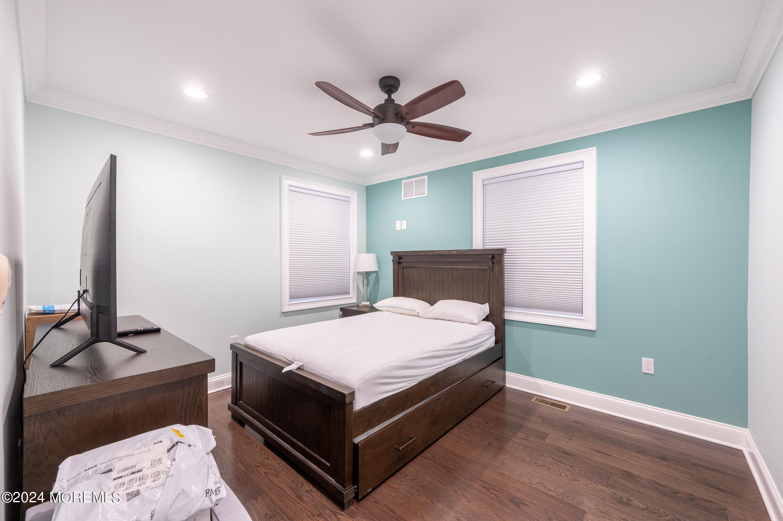 1851 Oceanfront Seaside Heights, NJ 08751 - Photo 47 of 66 a bedroom with a bed and a chandelier