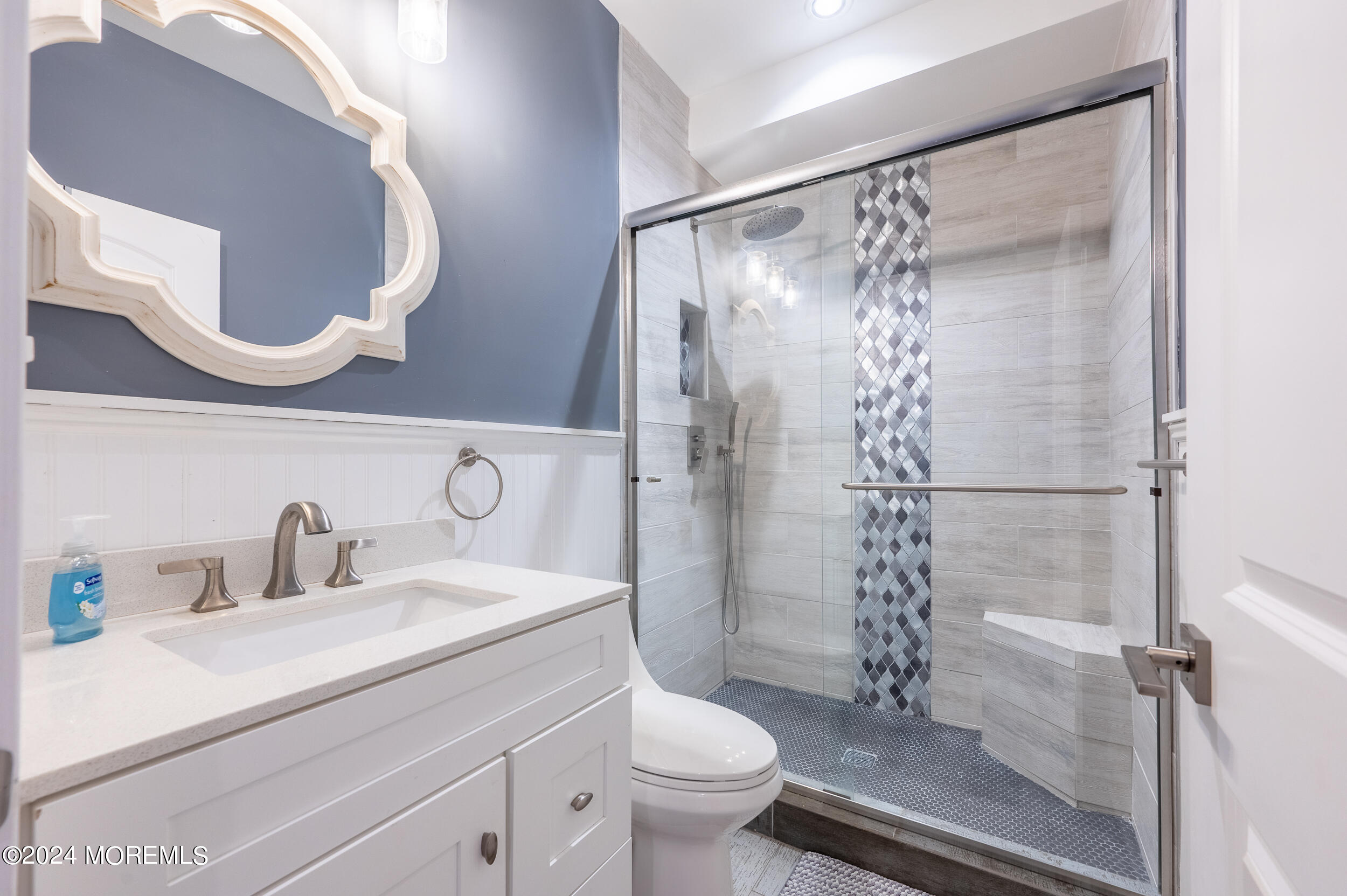 1851 Oceanfront Seaside Heights, NJ 08751 - Photo 48 of 66 a bathroom with a sink a toilet and a mirror