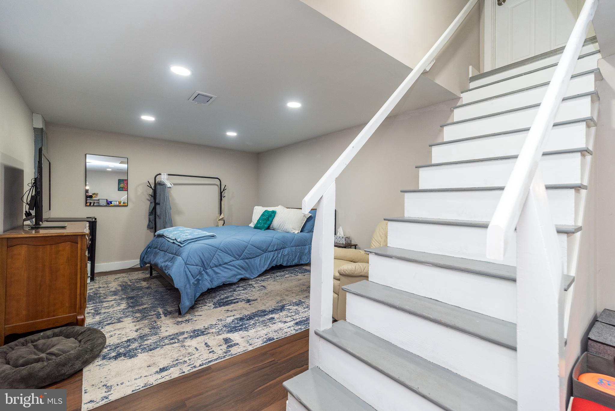 253 Luff Lane Warminster, PA 18974 - Photo 29 of 30 a bedroom with a large bed and a chandelier