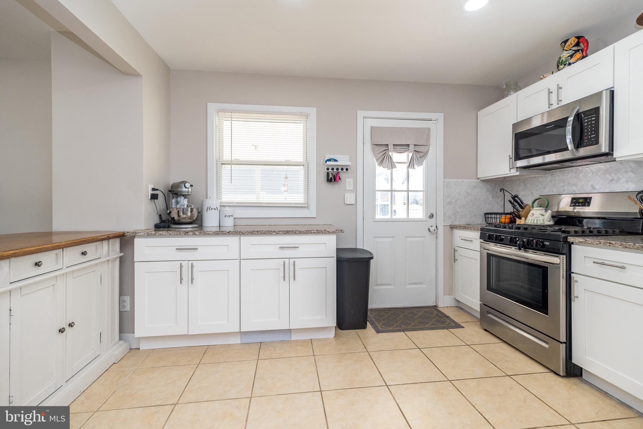 253 Luff Lane Warminster, PA 18974 - Photo 7 of 30 a kitchen with a stove a sink and a microwave