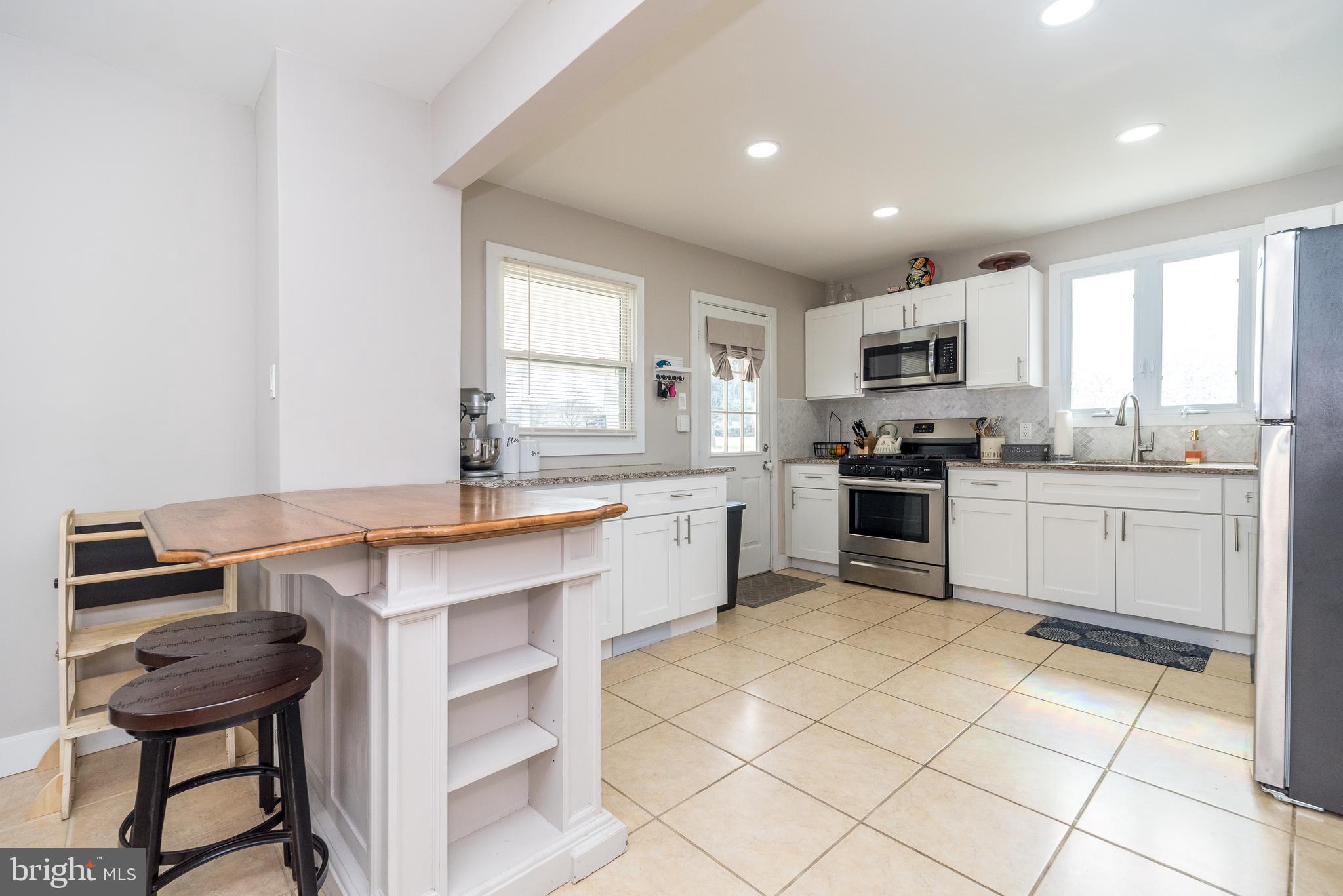 253 Luff Lane Warminster, PA 18974 - Photo 9 of 30 a kitchen with a sink cabinets and window