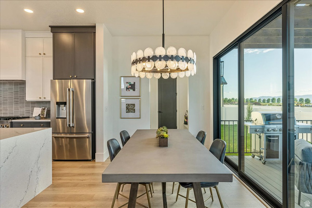 2458 West Aurora Avenue, Unit 287 Mapleton, UT 84664 - Photo 12 of 24 Dining space with light wood-style floors, recessed lighting, and a chandelier