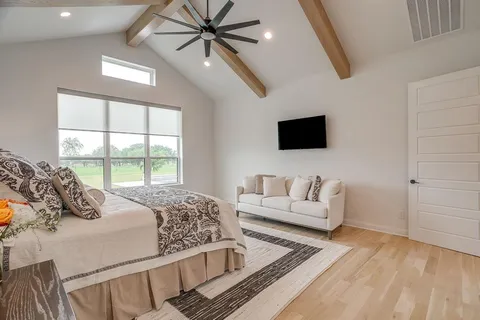 a bedroom with a bed and a flat screen tv