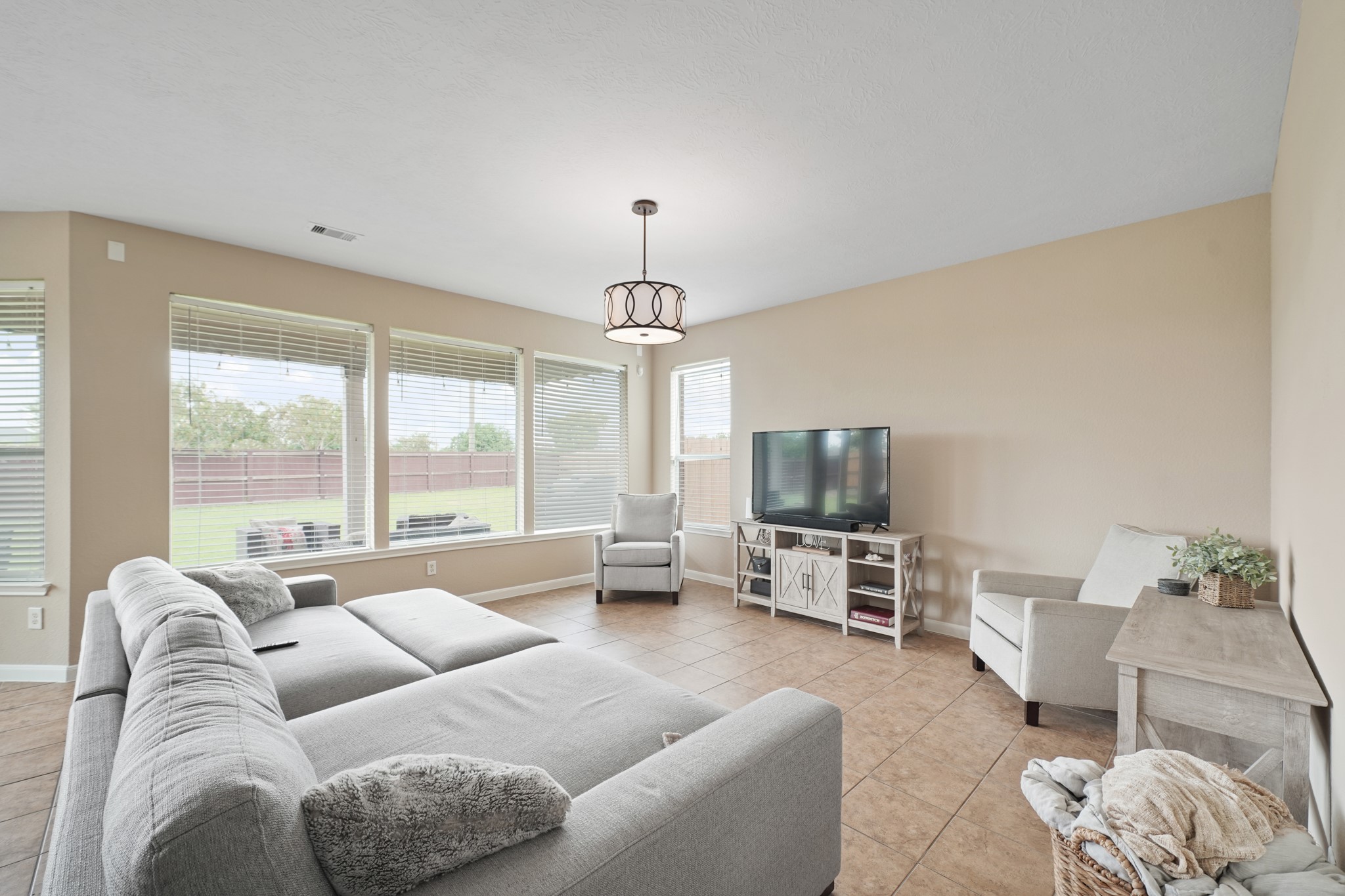 2502 J. R. Drive Manvel, TX 77578 - Photo 12 of 31 a living room with furniture large window and a flat screen tv