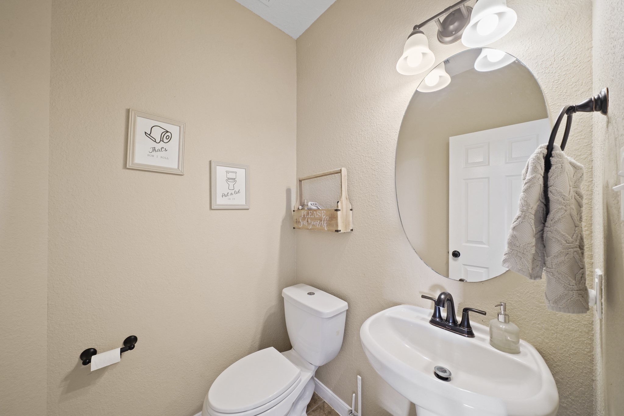 2502 J. R. Drive Manvel, TX 77578 - Photo 15 of 31 a bathroom with a toilet sink and mirror