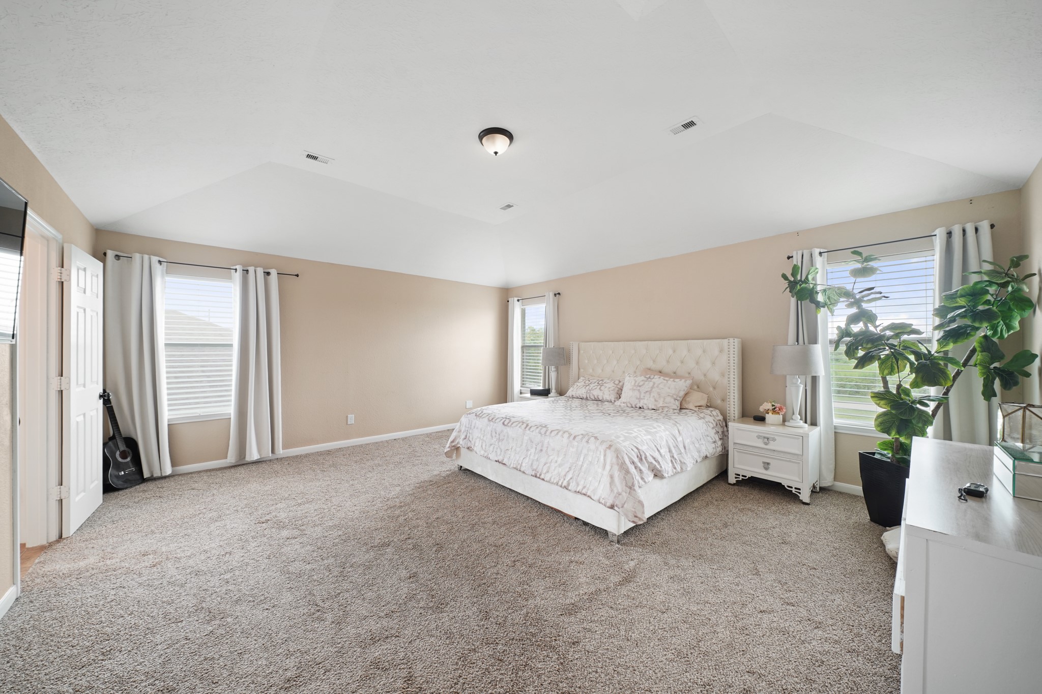 2502 J. R. Drive Manvel, TX 77578 - Photo 19 of 31 a spacious bedroom with a bed and a potted plant