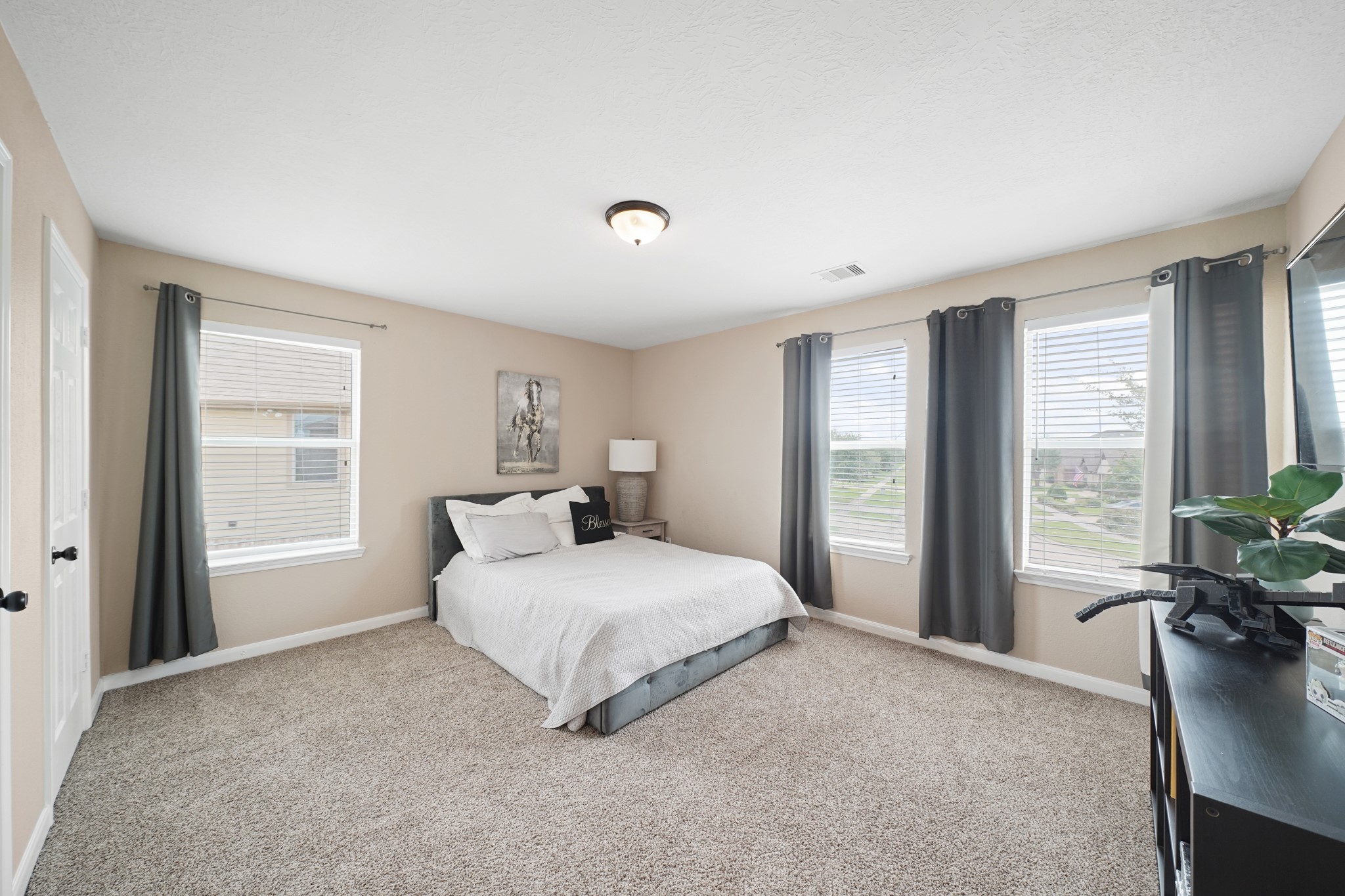 2502 J. R. Drive Manvel, TX 77578 - Photo 26 of 31 a bedroom with a bed and large windows