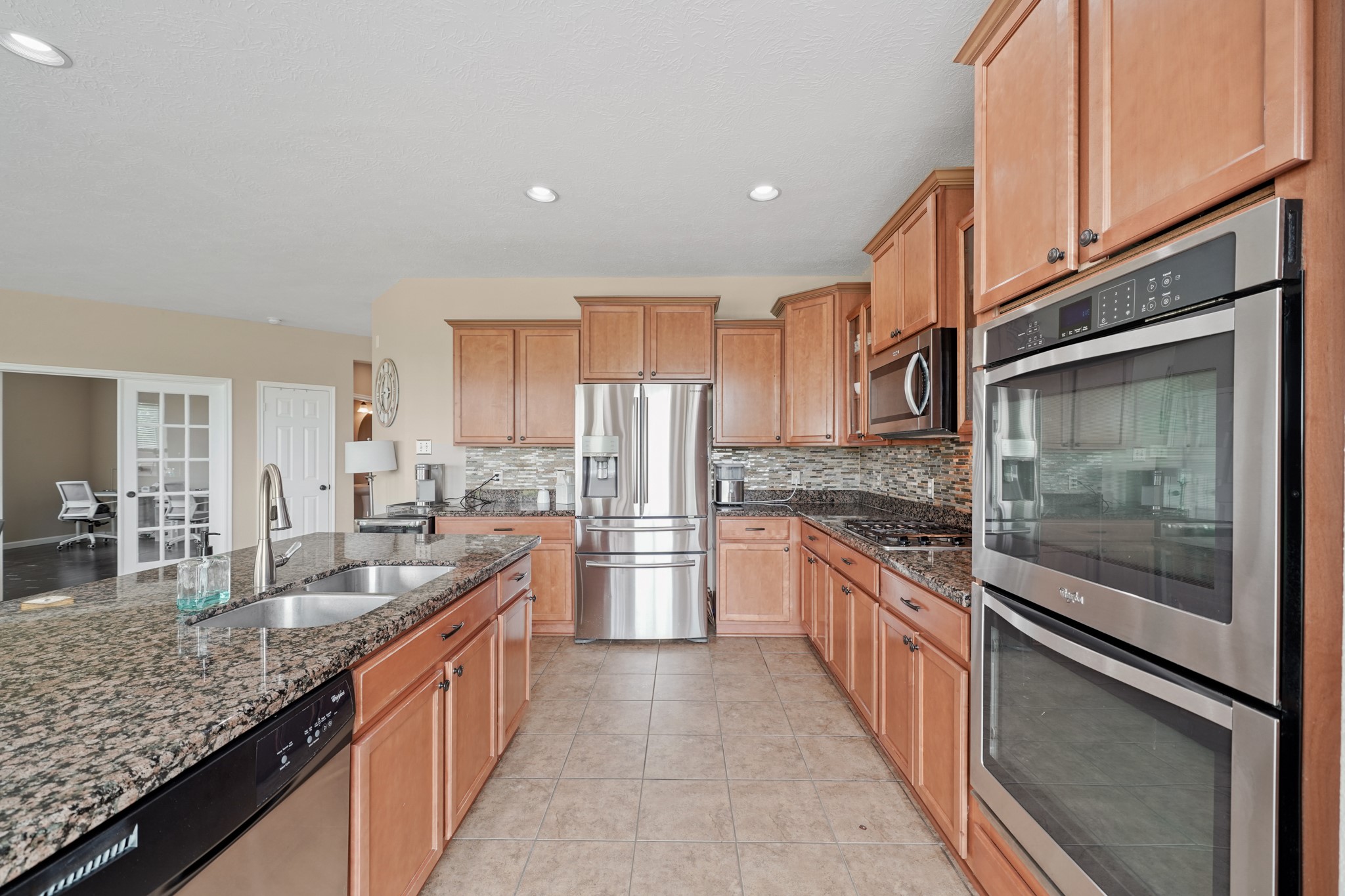 2502 J. R. Drive Manvel, TX 77578 - Photo 8 of 31 a large kitchen with granite countertop a large counter top space appliances and cabinets