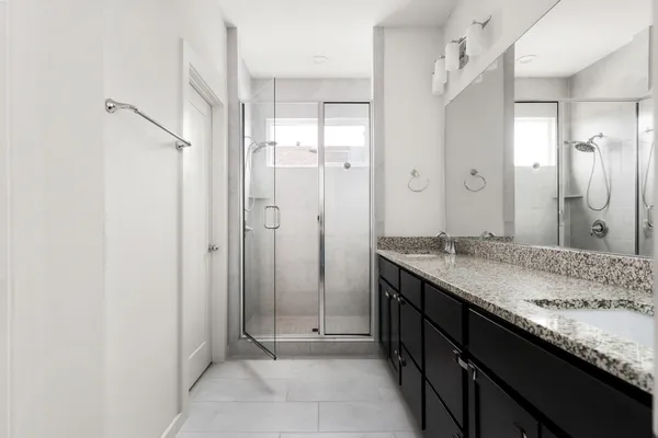 a bathroom with a granite countertop sink mirror and double