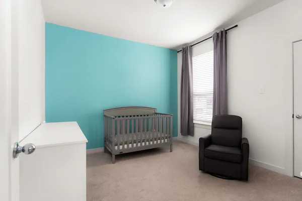 a bedroom with a couch and a window