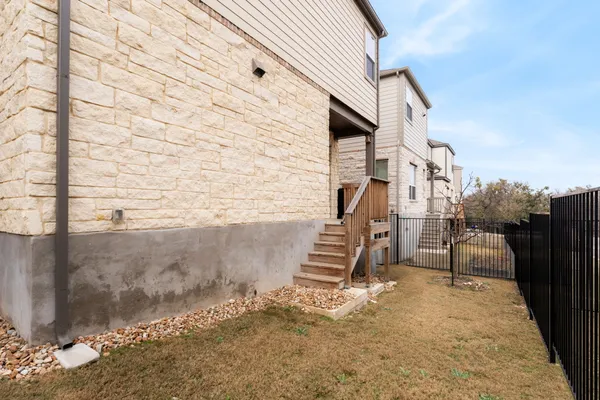 a view of a patio with wooden fence