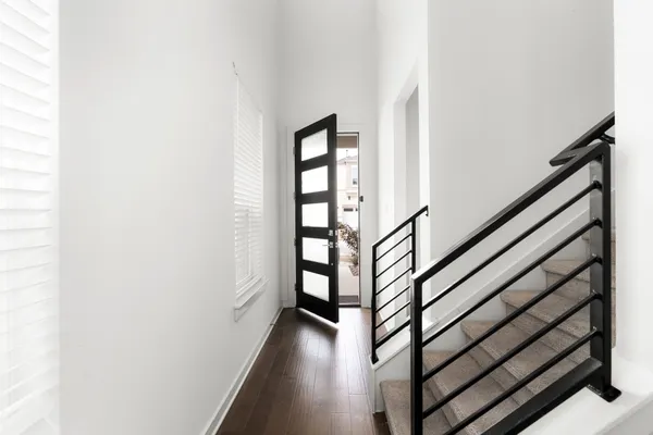 a view of entryway with wooden floor and stairs