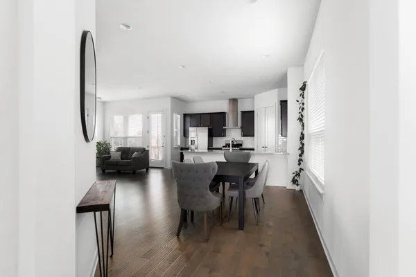 a view of a dining room with furniture and wooden floor