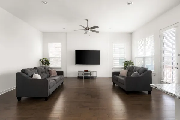 a living room with furniture window and a flat screen tv