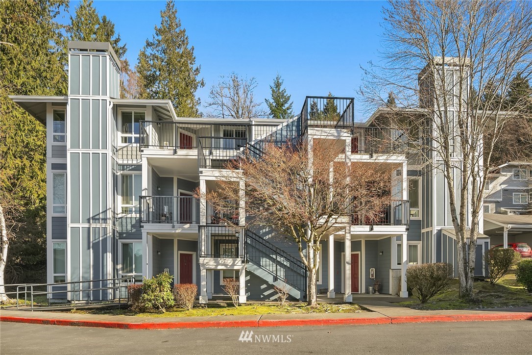 3926 243rd Place Southeast, Unit H301 Bothell, WA 98021 - Photo 1 of 16 a front view of a house with a yard