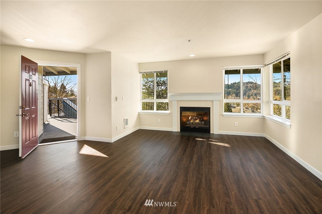 3926 243rd Place Southeast, Unit H301 Bothell, WA 98021 - Photo 3 of 16 a view of an empty room with wooden floor and a window