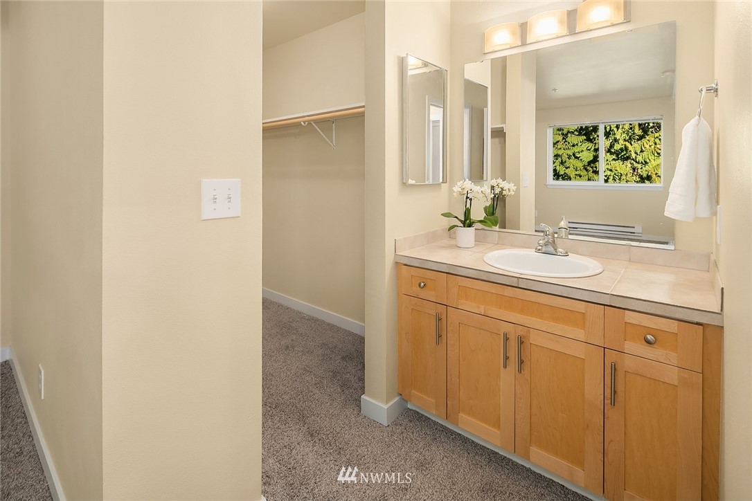 3926 243rd Place Southeast, Unit H301 Bothell, WA 98021 - Photo 8 of 16 a bathroom with a sink and a mirror