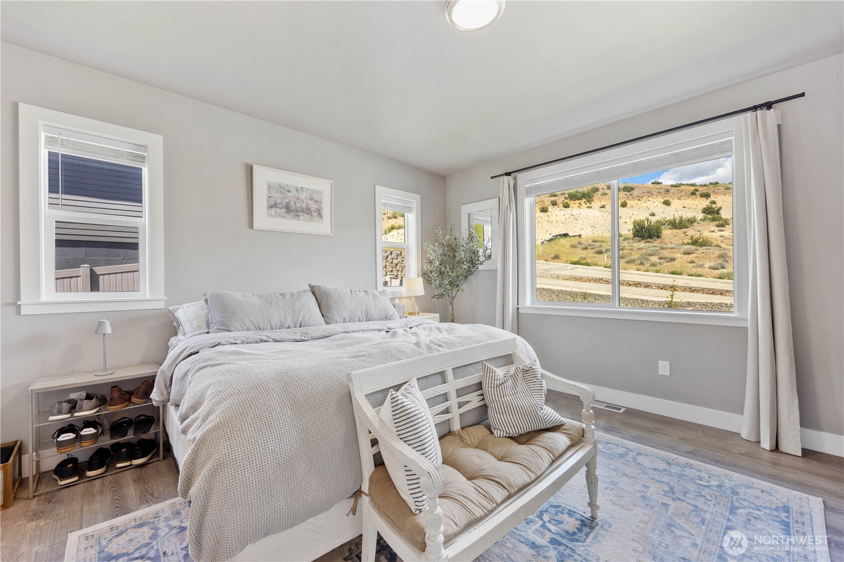 9968 Griffith Place Entiat, WA 98822 - Photo 14 of 38 a bed sitting in a bedroom next to a window