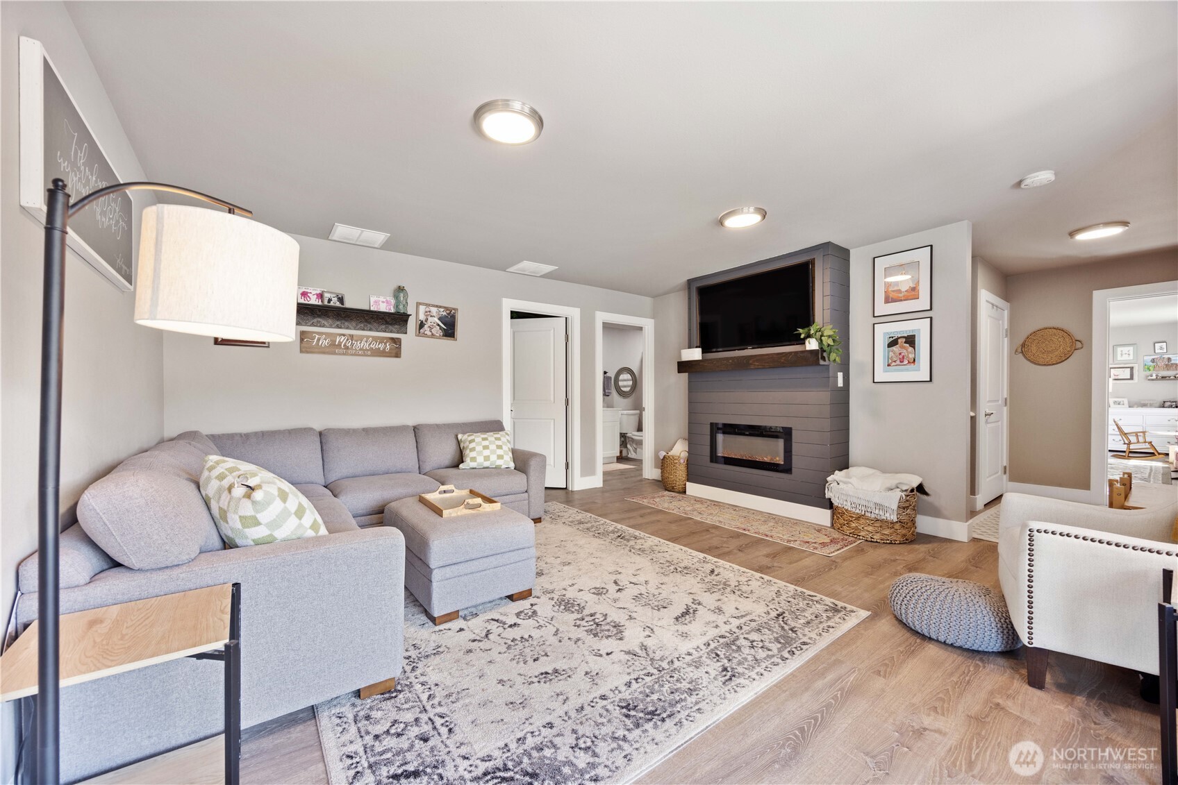 9968 Griffith Place Entiat, WA 98822 - Photo 22 of 38 a living room with furniture a flat screen tv and a fireplace