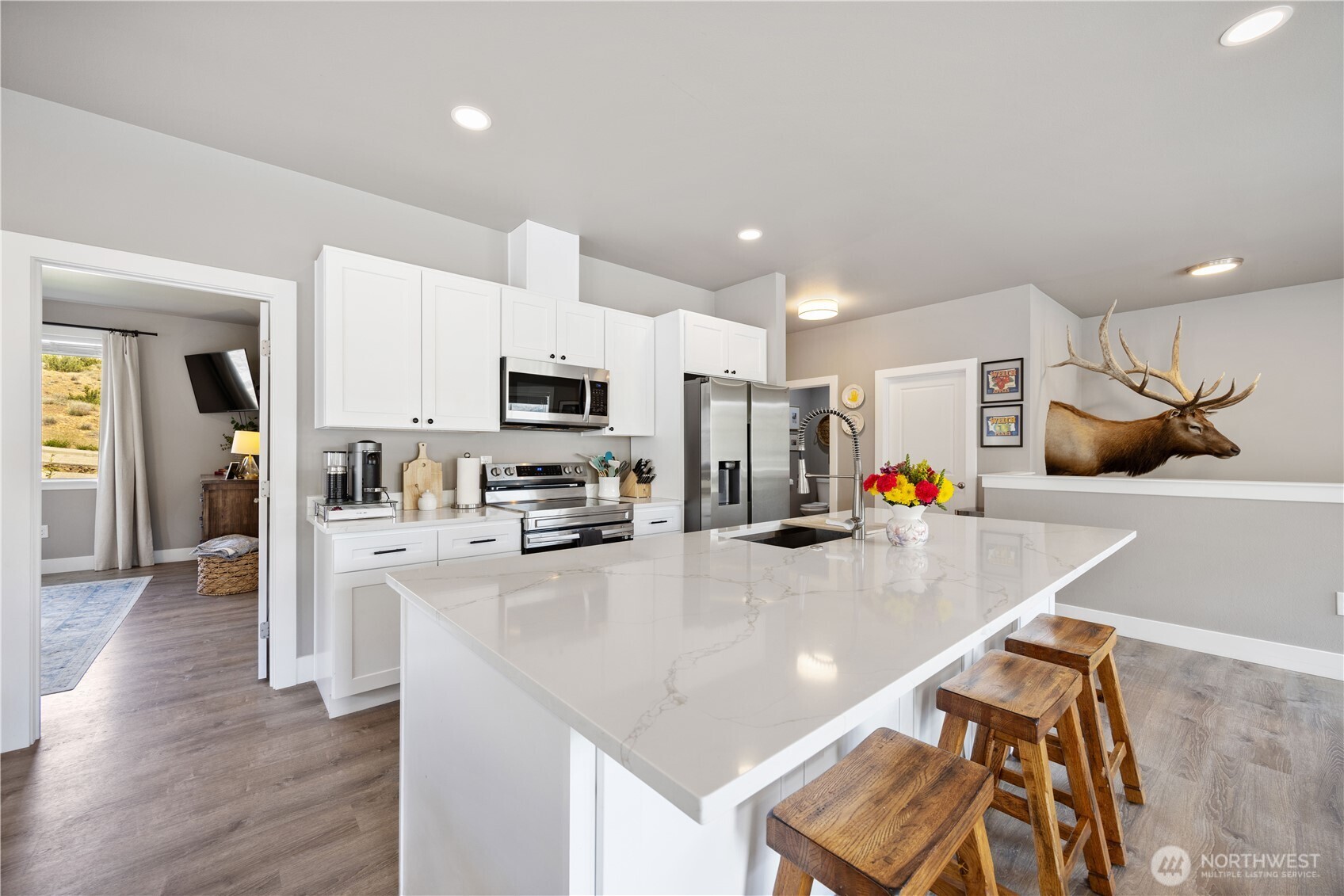 9968 Griffith Place Entiat, WA 98822 - Photo 9 of 38 a kitchen with stainless steel appliances a sink a stove a refrigerator cabinets and wooden floor