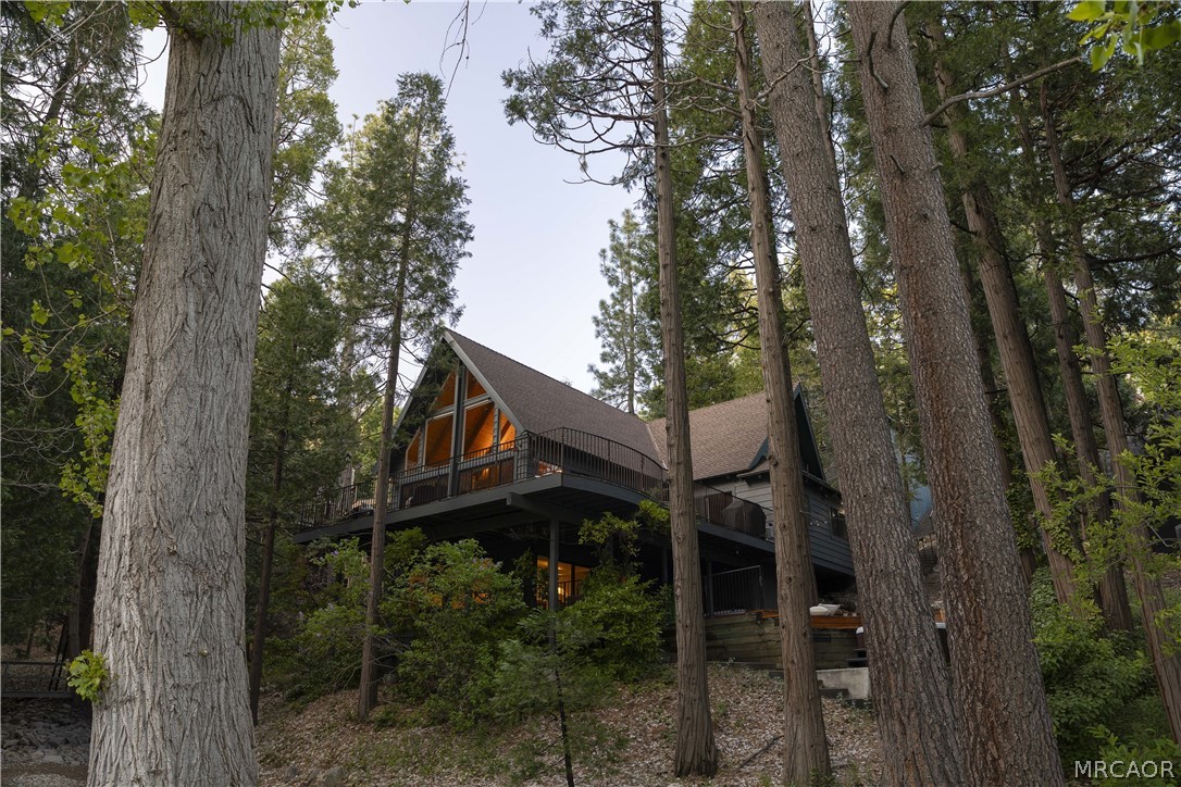 a view of a house next to a tree