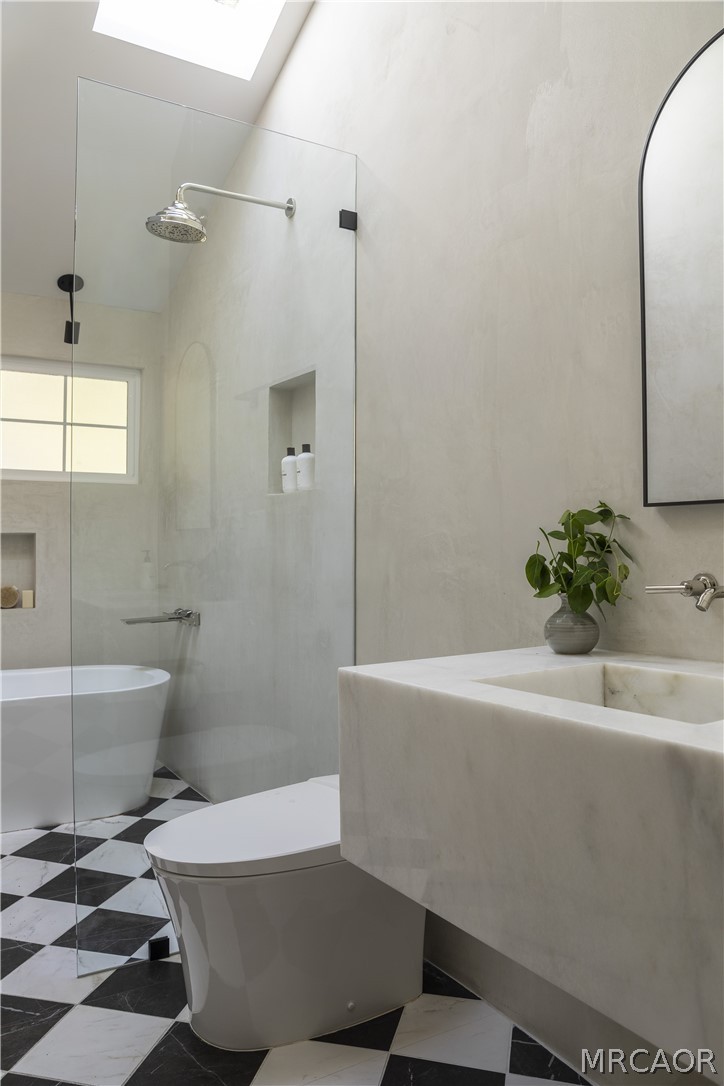 27643 West Shore Road, Unit 2 Lake Arrowhead, CA 92352 - Photo 16 of 28 a bath tub sitting next to a white toilet
