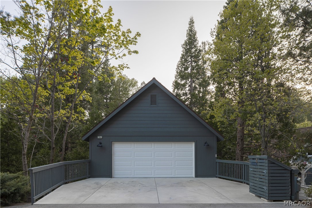 27643 West Shore Road, Unit 2 Lake Arrowhead, CA 92352 - Photo 28 of 28 a front view of house with yard and trees in the background