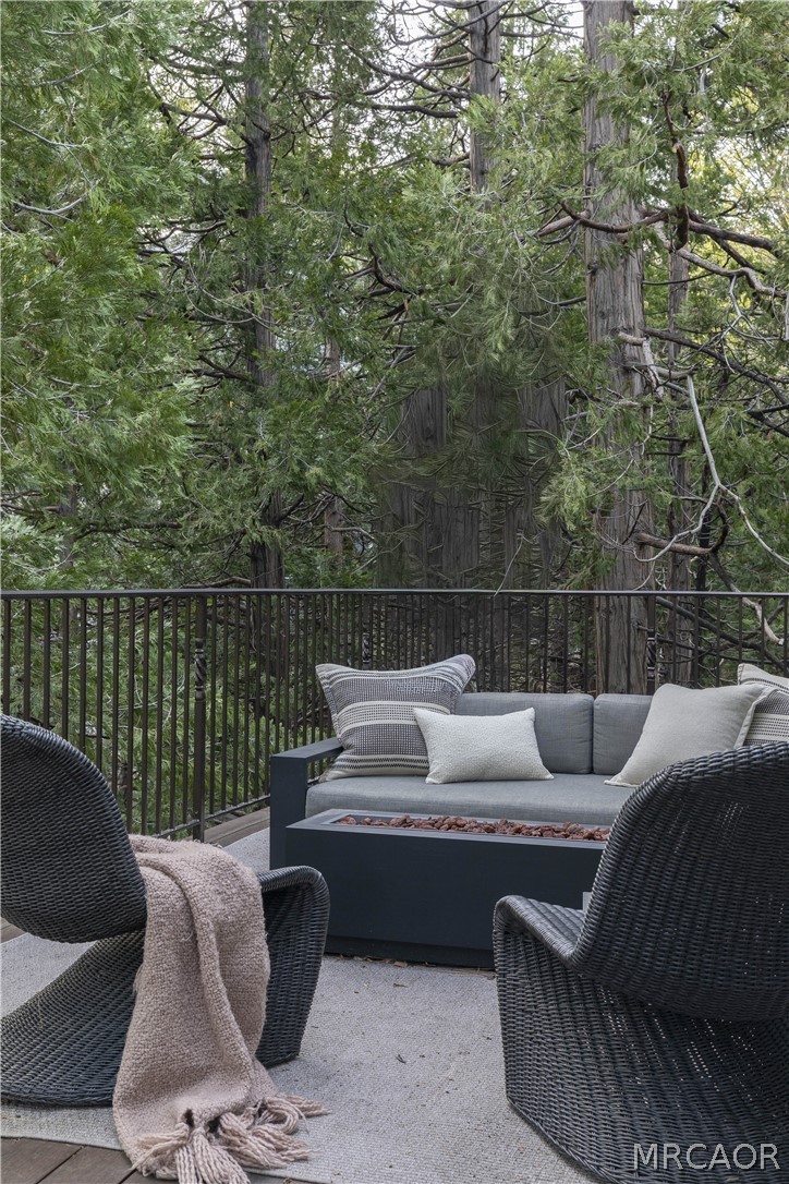 27643 West Shore Road, Unit 2 Lake Arrowhead, CA 92352 - Photo 10 of 28 a roof deck with couches and wooden fence