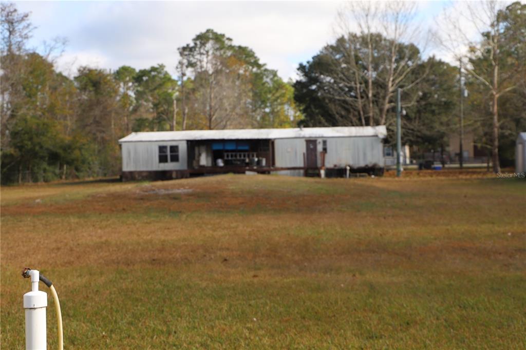 1332 Otis Road Jacksonville, FL 32220 - Photo 2 of 10 a view of a house with backyard and trees