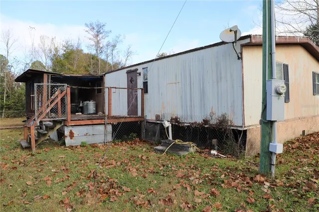 a view of a house with yard and sitting area