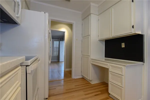 a view of walk in closet with wooden floor