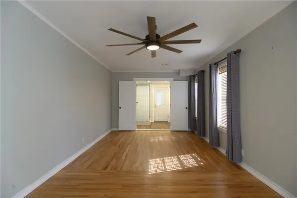 a view of a big room with wooden floor and windows in a room