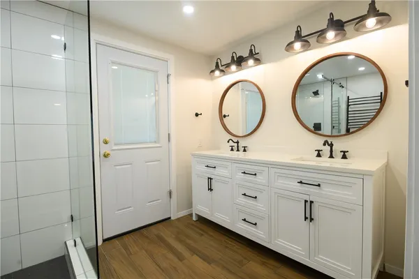 a bathroom with a double vanity sink and a mirror