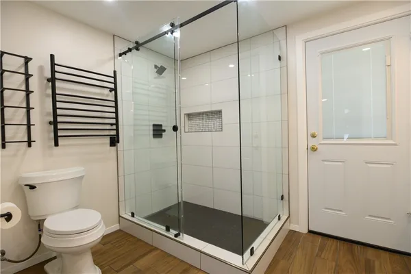 a bathroom with a shower and a toilet