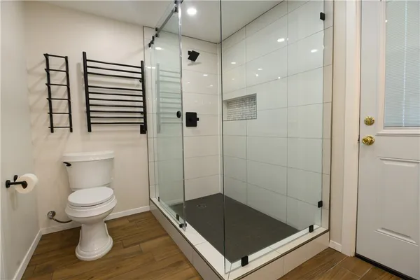 a bathroom with a shower and a toilet