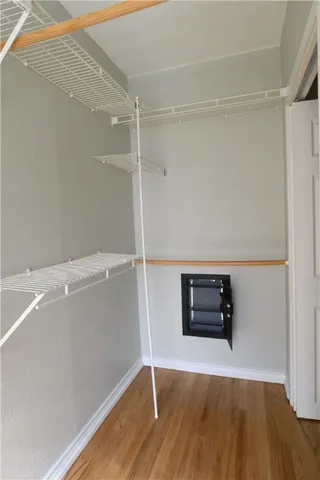a view of an empty room with cabinet and a window