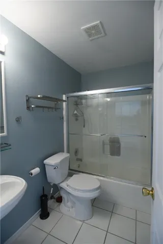 a bathroom with a toilet a sink and shower