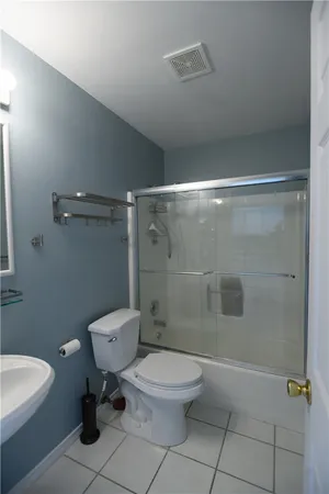a bathroom with a toilet a sink and shower