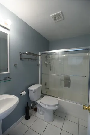 a bathroom with a toilet a sink and shower