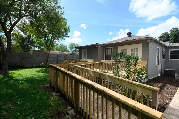 a view of a house with backyard and sitting area