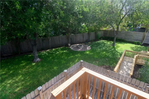 a view of a backyard with a small cabin and wooden fence