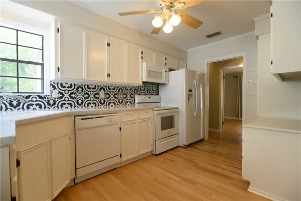 a kitchen with cabinets a sink and appliances