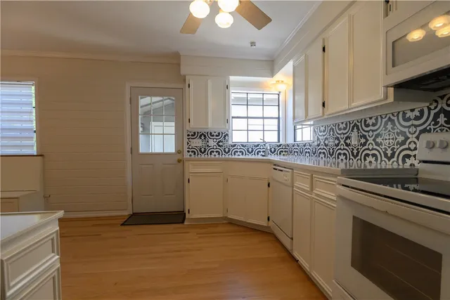 a kitchen with a sink stove and cabinets