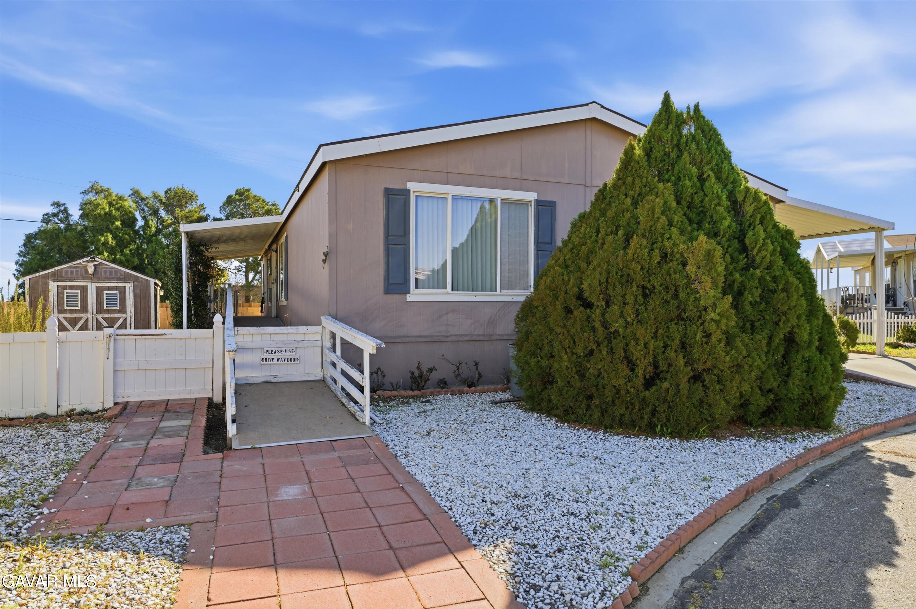 a view of a house with a yard and plants