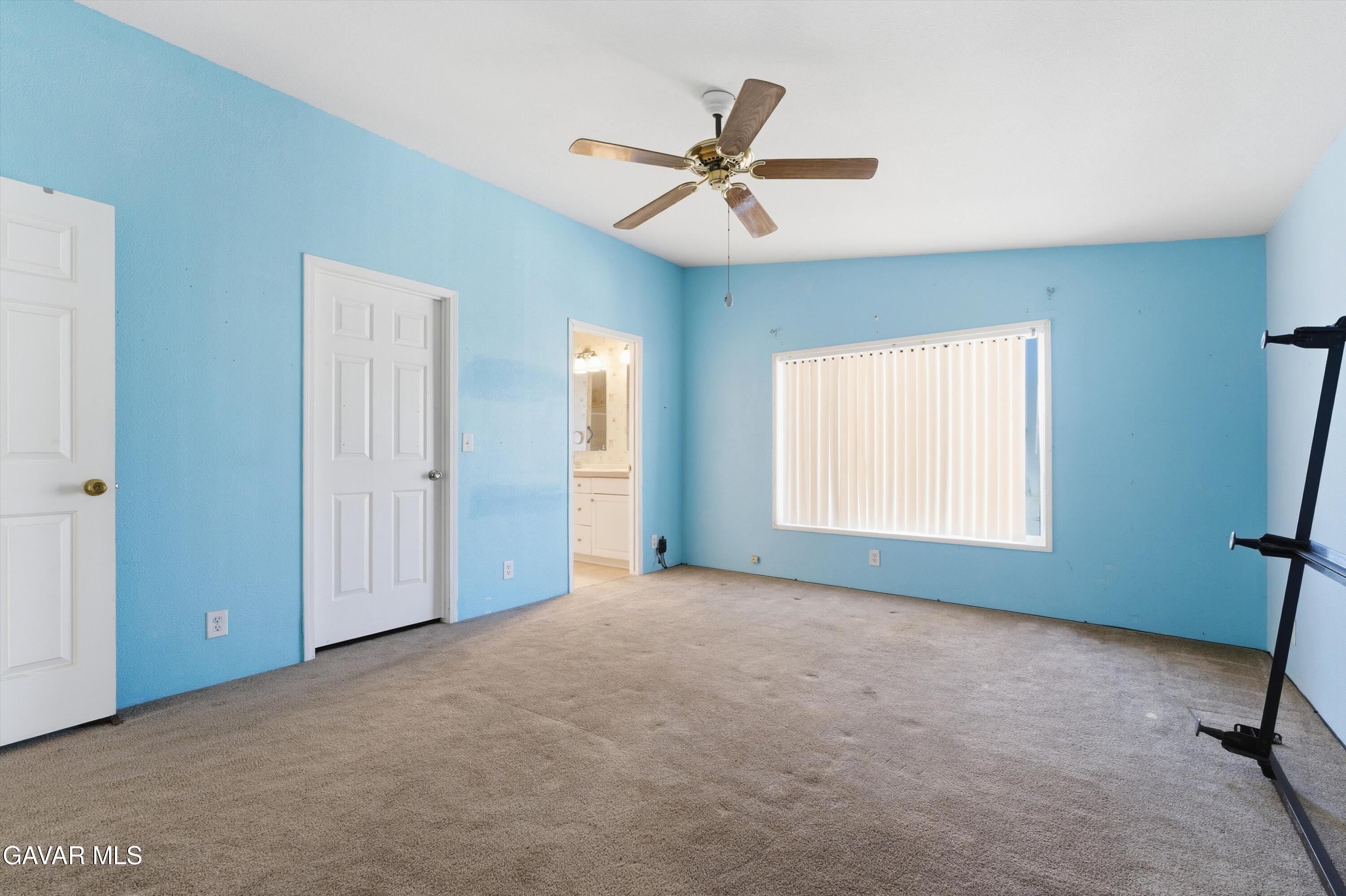 1900 Sandra Way Rosamond, CA 93560 - Photo 11 of 20 a view of a livingroom with a ceiling fan and window