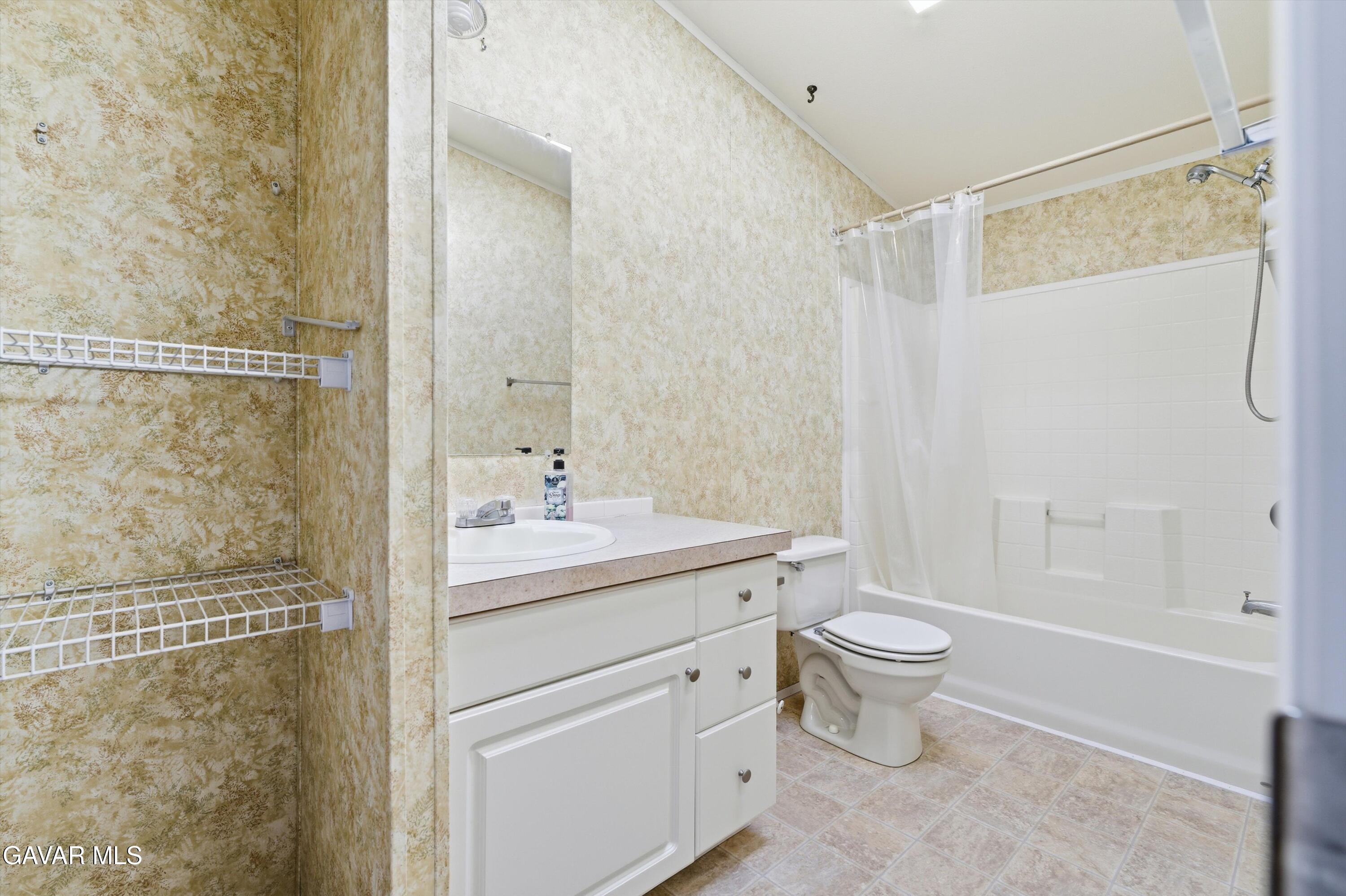 1900 Sandra Way Rosamond, CA 93560 - Photo 15 of 20 a bathroom with a double vanity sink toilet and shower