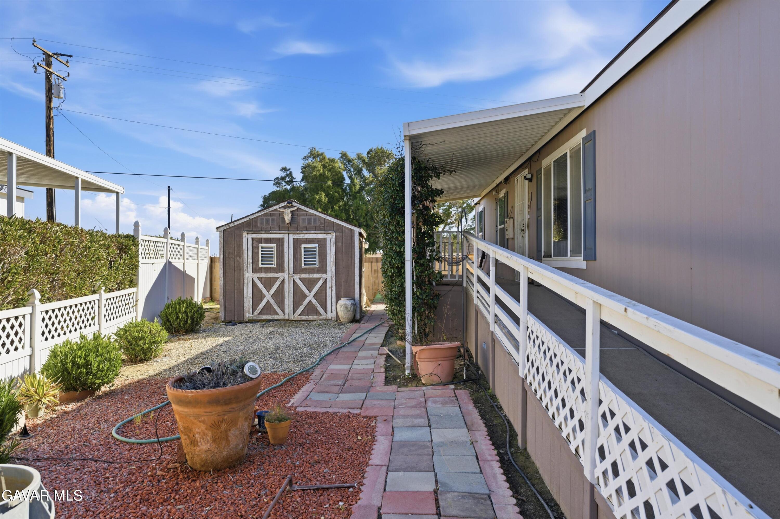 1900 Sandra Way Rosamond, CA 93560 - Photo 16 of 20 a front view of a house with garden