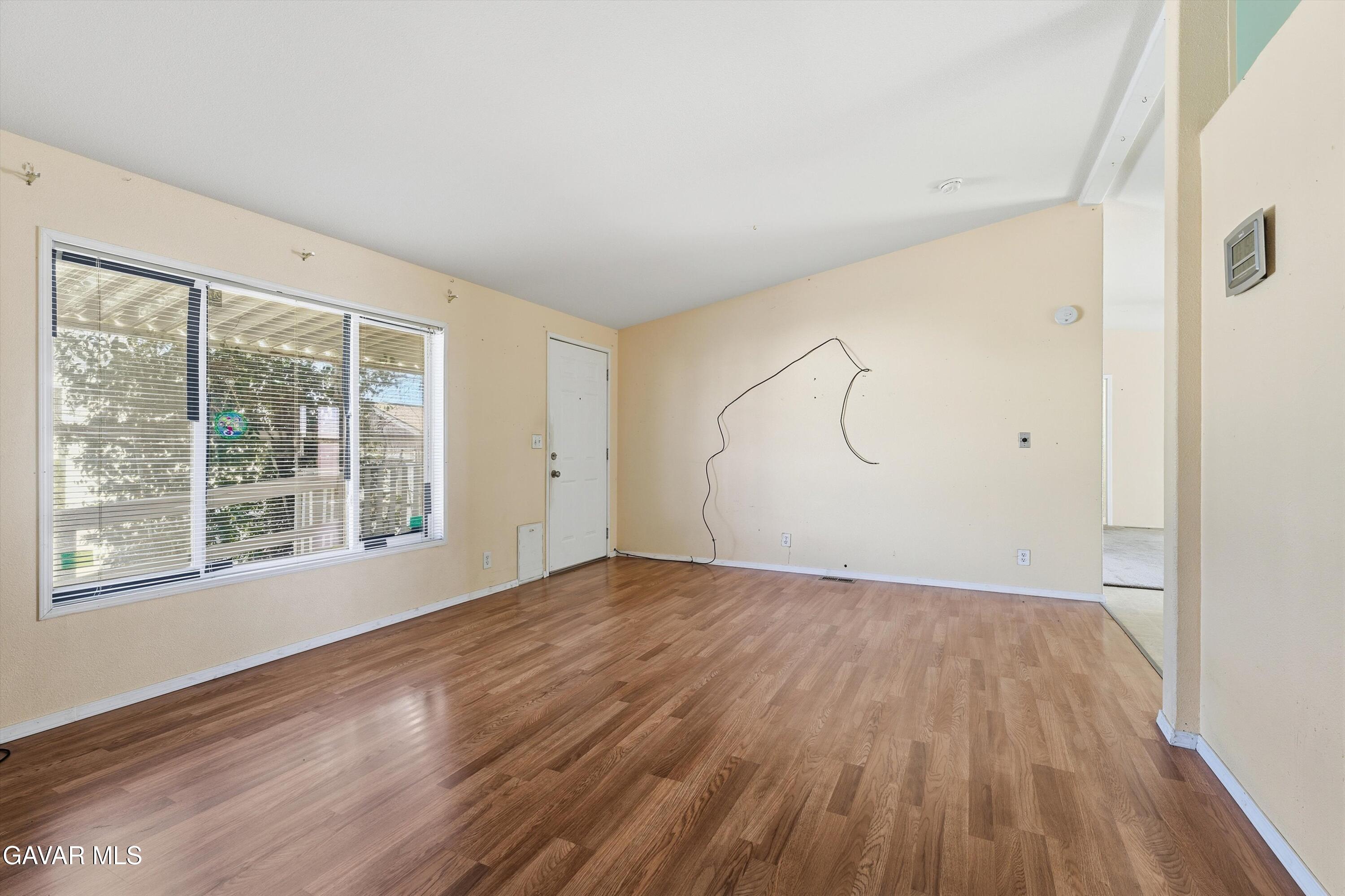 1900 Sandra Way Rosamond, CA 93560 - Photo 5 of 20 a view of empty room with wooden floor and fan